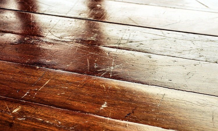 How else can you prevent scratches in your hardwood floor?