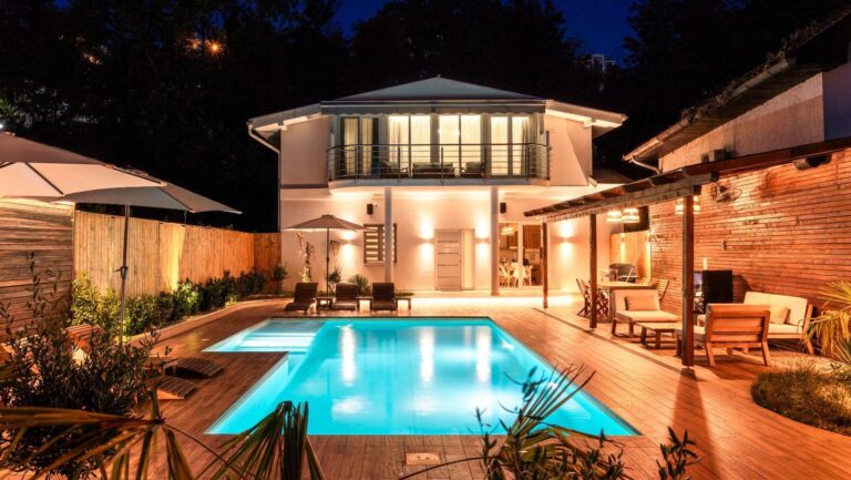 outdoor pool design, resort style pool area, backyard pool features, luxury poolside ideas, outdoor living spaces, poolside landscaping, backyard resort atmosphere, outdoor entertainment area, premium pool features, backyard luxury design